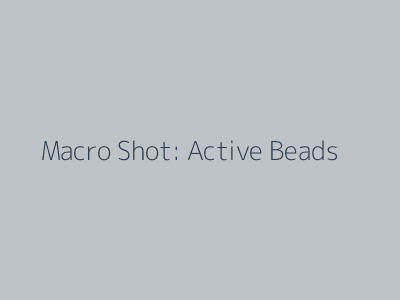 Macro photography of encapsulated skincare beads suspended in serum