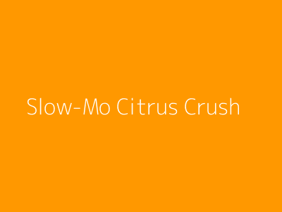 Slow motion crush of an orange releasing juice