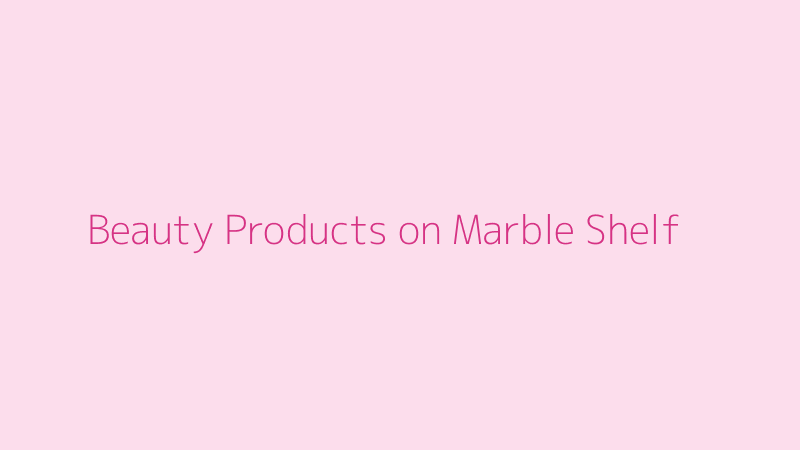 A curated 'shelfie' of aesthetic beauty products on a marble surface